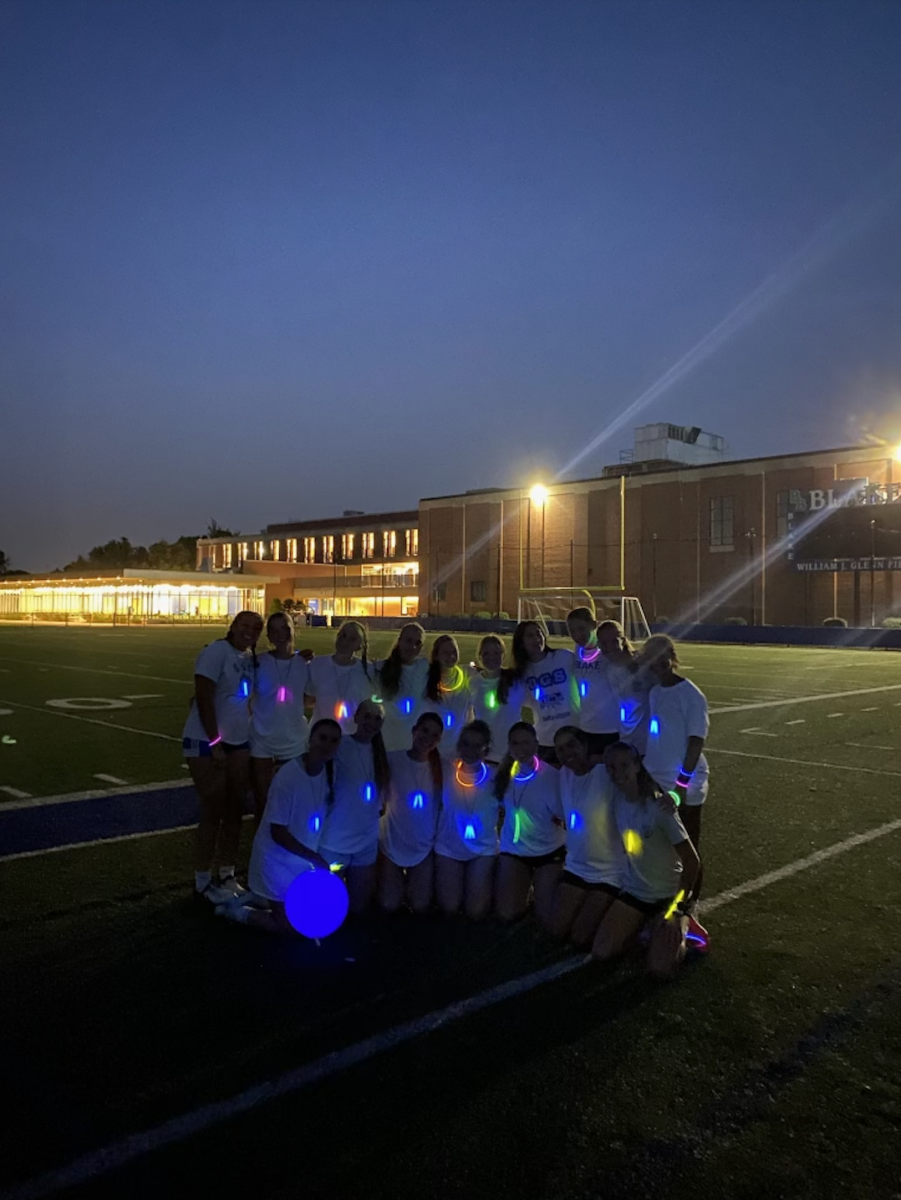 The girls’ varsity soccer team at a night practice/event using glow sticks to build team chemistry and add more
enjoyment into an already fun experience.